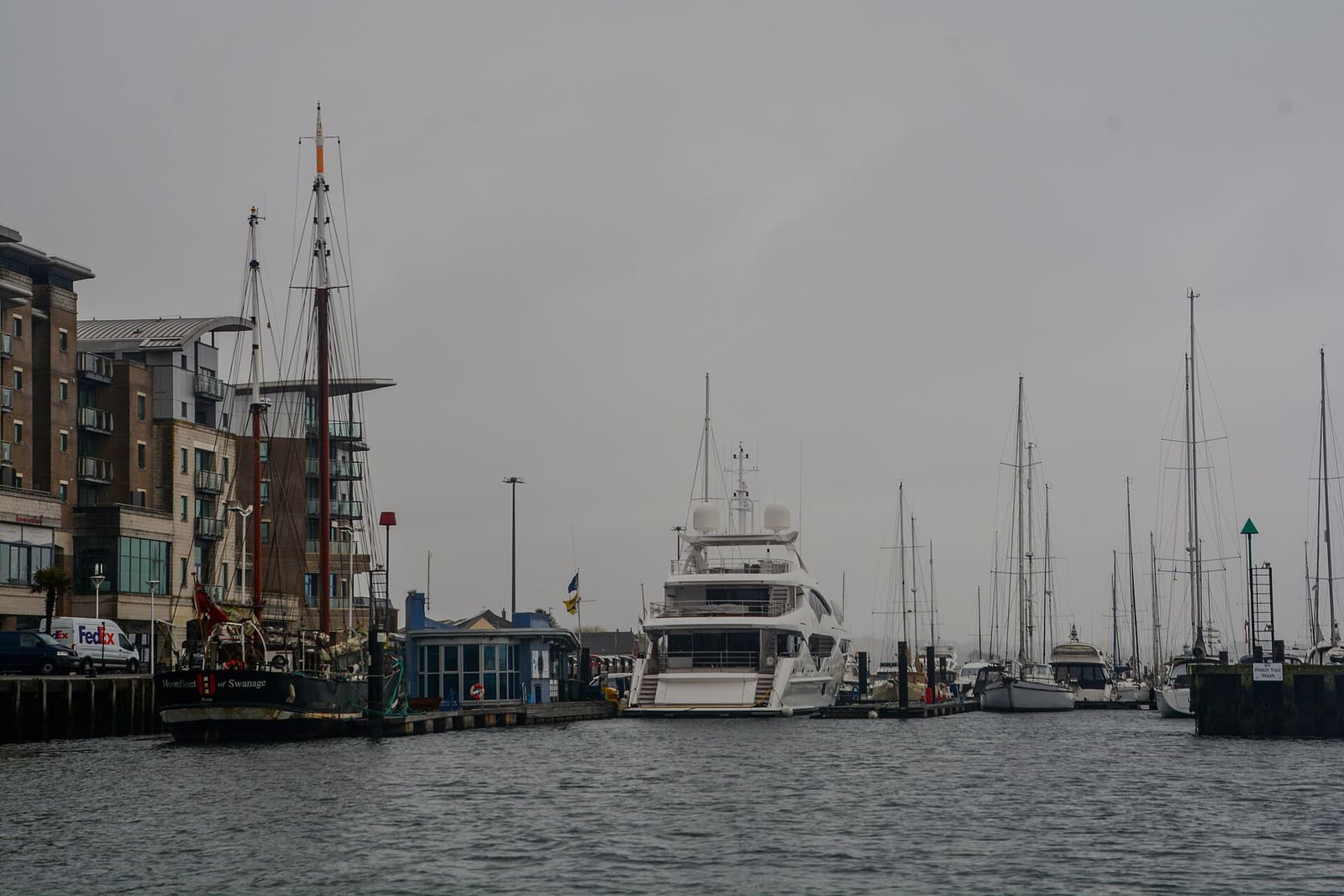 Boats moored along Poole Quay